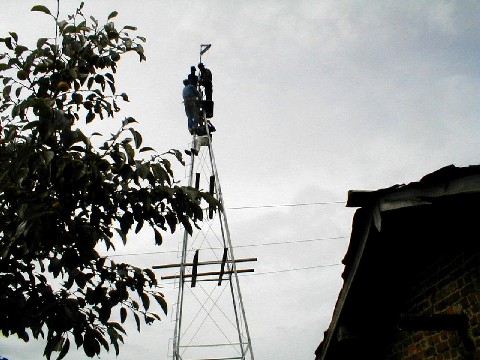 Crews work together atop tower