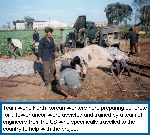North Korean workers prepare concrete for a wind turbine anchor